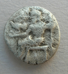 A fifth-century B.C. silver coin - about the size of a nickel - depicts Zeus.